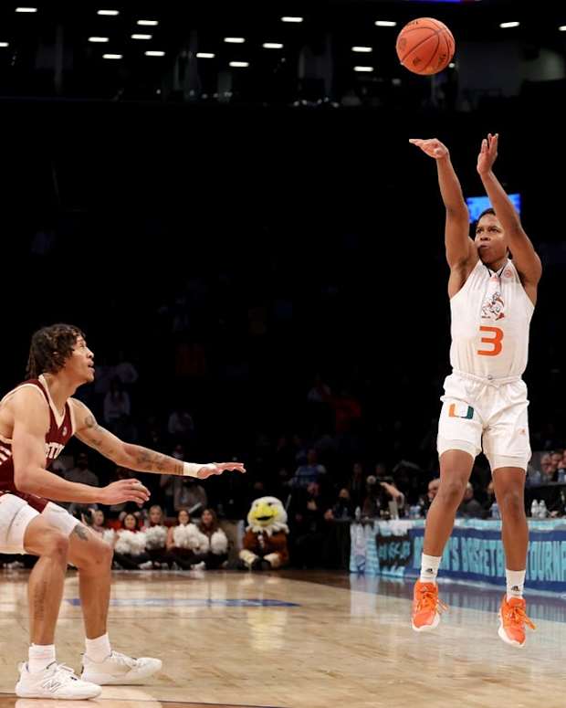 Mar 10, 2022; Brooklyn, NY, USA; Miami Hurricanes guard Charlie Moore (3) shoots a three point shot against Boston College Eagles guard Makai Ashton-Langford (11) during overtime at Barclays Center. Mandatory Credit: Brad Penner-USA TODAY Sports